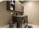Laundry room featuring a modern washer and dryer with storage cabinets at 4913 Sunset Stream Dr, Fuquay Varina, NC 27526