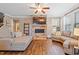 Inviting living room with stone fireplace, providing a comfortable and stylish space for relaxation at 4913 Sunset Stream Dr, Fuquay Varina, NC 27526