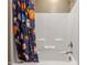Bright shower with sports-themed shower curtain and a built-in seat at 4913 Sunset Stream Dr, Fuquay Varina, NC 27526