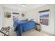 Cozy bedroom with natural light, blue bedding, neutral carpet, and stylish decor at 505 Ferry Ct, Wake Forest, NC 27587