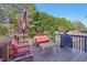 Deck featuring outdoor furniture, an umbrella, and a grill overlooking lush green trees at 505 Ferry Ct, Wake Forest, NC 27587
