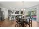 Dining area open to the kitchen with dark wood table and chairs, ample natural light, and deck access at 505 Ferry Ct, Wake Forest, NC 27587