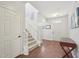 Bright foyer featuring hardwood floors, a staircase with white railings, and neutral wall colors at 505 Ferry Ct, Wake Forest, NC 27587