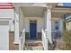 Close-up showcasing the inviting front porch with brick accents and a classic blue entry door at 505 Ferry Ct, Wake Forest, NC 27587