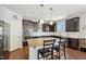 Kitchen island with granite countertop and stainless steel appliances with dark wood cabinets at 505 Ferry Ct, Wake Forest, NC 27587