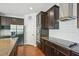 Modern kitchen with stainless steel appliances, granite countertops and dark wood cabinets at 505 Ferry Ct, Wake Forest, NC 27587