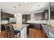 Gourmet kitchen features stainless steel appliances and large center island with dark wood cabinets at 505 Ferry Ct, Wake Forest, NC 27587