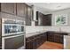 Modern kitchen with stainless steel appliances and dark wood cabinets at 505 Ferry Ct, Wake Forest, NC 27587