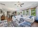 Open-concept living room showcasing a white sectional sofa, large windows, and a stylish area rug at 505 Ferry Ct, Wake Forest, NC 27587