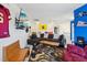 Spacious living room with a brown sectional sofa, rustic coffee table, and sports-themed decor at 505 Ferry Ct, Wake Forest, NC 27587