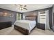 Bedroom with a large bed, dark gray walls, and natural light at 505 Ferry Ct, Wake Forest, NC 27587