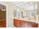 Bathroom with dual vanities, a large mirror, and a doorway into another room at 508 Spencer Crest Ct, Cary, NC 27513