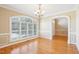 Formal dining area featuring hardwood floors, large windows, and detailed architectural molding at 508 Spencer Crest Ct, Cary, NC 27513