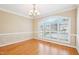 Bright dining room with hardwood floors, crown molding, and a large window with shutters at 508 Spencer Crest Ct, Cary, NC 27513
