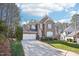 Traditional brick home with an attached two-car garage and a well-maintained lawn and shrubbery at 508 Spencer Crest Ct, Cary, NC 27513