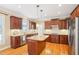 Spacious kitchen with wood cabinets, granite countertops, stainless steel appliances and island at 508 Spencer Crest Ct, Cary, NC 27513