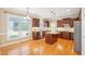 Bright kitchen featuring an island, wood cabinets, stainless steel appliances, and a sunlit breakfast nook at 508 Spencer Crest Ct, Cary, NC 27513