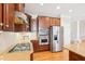 Modern kitchen featuring stainless steel appliances, granite countertops, and wood cabinetry at 508 Spencer Crest Ct, Cary, NC 27513