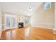Spacious living room with a fireplace, French doors, and a large window with transom bringing in natural light at 508 Spencer Crest Ct, Cary, NC 27513