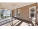 Inviting screened-in porch with brick accents, ceiling fan and wood flooring, ideal for relaxation at 508 Spencer Crest Ct, Cary, NC 27513