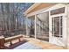 Relaxing screened porch with seating, a wooden deck, and serene views of the surrounding trees at 508 Spencer Crest Ct, Cary, NC 27513