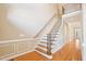 Elegant staircase featuring wood treads, white risers, and decorative molding on the wall at 508 Spencer Crest Ct, Cary, NC 27513