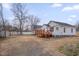 This backyard has a spacious yard, shed, driveway, and a red wooden deck at 516 Craven Road, Durham, NC 27704