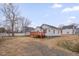 This backyard has a spacious yard, driveway, and a red wooden deck at 516 Craven Road, Durham, NC 27704