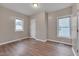 This bedroom has a spacious closet, two bright windows and sleek, clean laminate floors at 516 Craven Road, Durham, NC 27704
