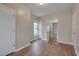 Spacious bedroom with wood-look vinyl floors, neutral paint, and an attached bathroom at 516 Craven Road, Durham, NC 27704