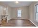 Bedroom featuring wood-look flooring, a large window, and an attached bathroom at 516 Craven Road, Durham, NC 27704