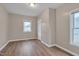 Bedroom with wood-look vinyl floors, neutral paint and a good-sized closet at 516 Craven Road, Durham, NC 27704