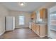 Open kitchen features wood cabinets, white appliances, stainless steel sink, and wood-look flooring at 516 Craven Road, Durham, NC 27704