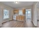Well-lit kitchen with wood cabinets, white appliances, and a stainless steel sink. Wood-look floors throughout at 516 Craven Road, Durham, NC 27704