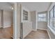 Bright laundry area features wood-look floors, utility sink, and a large window offering plenty of natural light at 516 Craven Road, Durham, NC 27704
