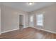 Open living room with neutral paint, wood look vinyl flooring, and views to other rooms at 516 Craven Road, Durham, NC 27704