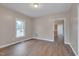 Cozy living room with wood-look flooring, neutral paint, and a large window for natural light at 516 Craven Road, Durham, NC 27704