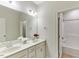 Bright bathroom features a double sink vanity with white cabinets and a shower-tub combo at 627 Balsam Fir Dr, Cary, NC 27519