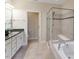 A luxurious bathroom showcasing a double vanity, soaking tub, and frameless glass shower enclosure at 627 Balsam Fir Dr, Cary, NC 27519