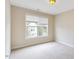 Cozy bedroom features a window with blinds and soft carpet at 627 Balsam Fir Dr, Cary, NC 27519