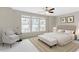 Comfortable primary bedroom with a ceiling fan, a bench and an abundance of natural light at 627 Balsam Fir Dr, Cary, NC 27519