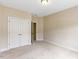 Carpeted bedroom includes a closet with double doors and neutral paint at 627 Balsam Fir Dr, Cary, NC 27519