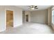 Large bedroom with an ensuite bathroom and walk in closet featuring neutral walls and plush carpet at 627 Balsam Fir Dr, Cary, NC 27519
