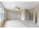 Expansive room with neutral decor featuring plush carpeting, ceiling fan, and ample natural light at 627 Balsam Fir Dr, Cary, NC 27519