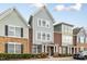 Charming townhouses with brick and siding exteriors, manicured landscaping, and covered entrances at 627 Balsam Fir Dr, Cary, NC 27519