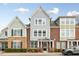 Charming townhouse with brick and siding exterior, manicured landscaping, and covered entrance at 627 Balsam Fir Dr, Cary, NC 27519