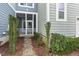 Charming front porch with decorative landscaping and stone path at 627 Balsam Fir Dr, Cary, NC 27519