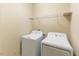 Convenient laundry room with washer, dryer, and overhead storage shelves at 627 Balsam Fir Dr, Cary, NC 27519