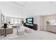 Spacious living room with modern furniture, entertainment center and natural light from windows at 627 Balsam Fir Dr, Cary, NC 27519