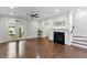 Bright living room with a fireplace, hardwood floors, and direct access to the outdoors at 627 Balsam Fir Dr, Cary, NC 27519